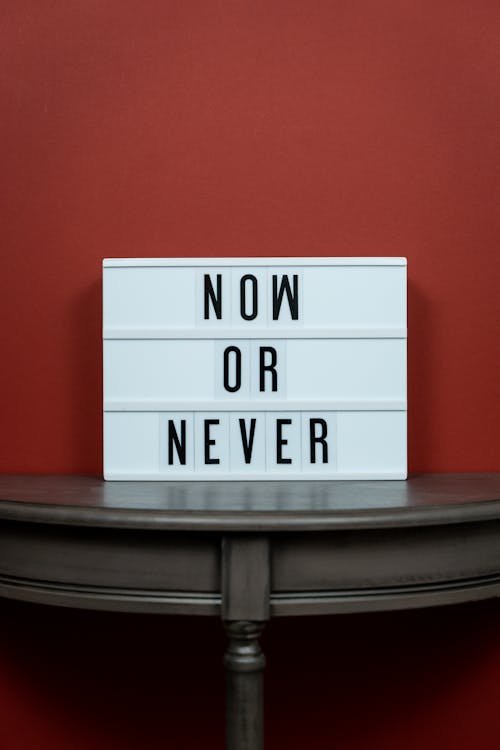 White Letter Board on Wooden Surface