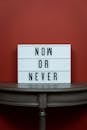 White Letter Board on Wooden Surface