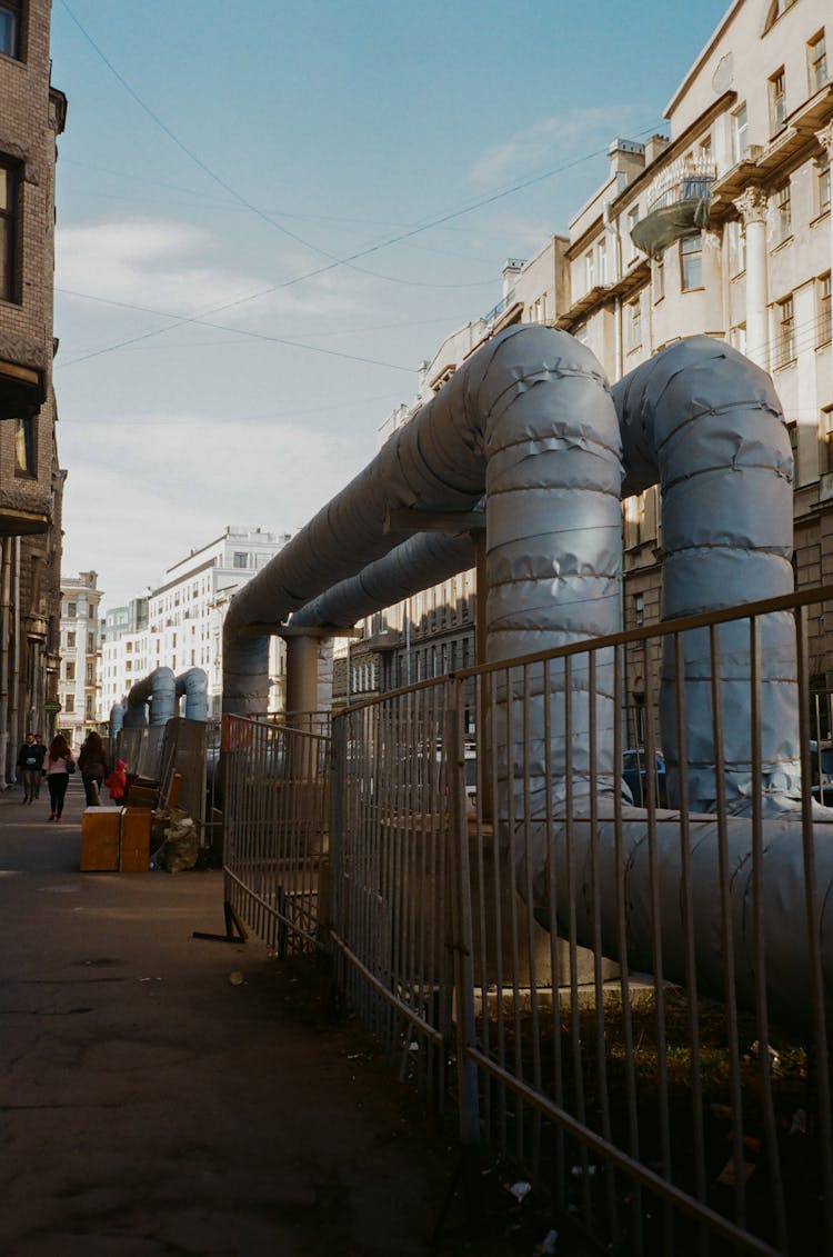 Water Pipeline System Near Residential House On Pavement In City