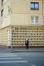 Unrecognizable man near crosswalk and old building in city