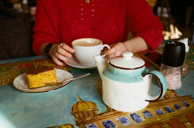 Unrecognizable Woman With Coffee And Delicious Cake In Cafe