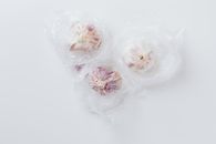 Three Garlic Bulbs Inside Clear Plastic Bag