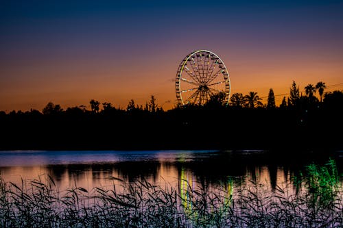 Silhouette of Ferris Wheel during Sunset