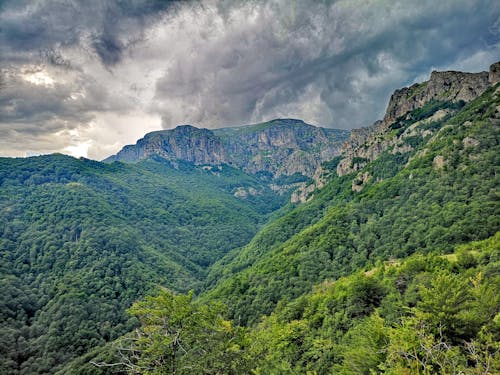 Green Mountains Under Cloudy Sky