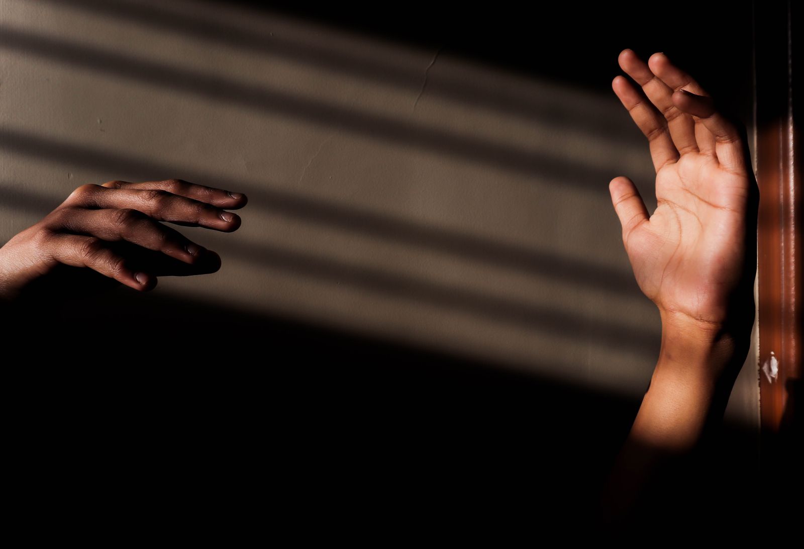 Hands lit by slatted daylight — Raghav Modi on Pexels