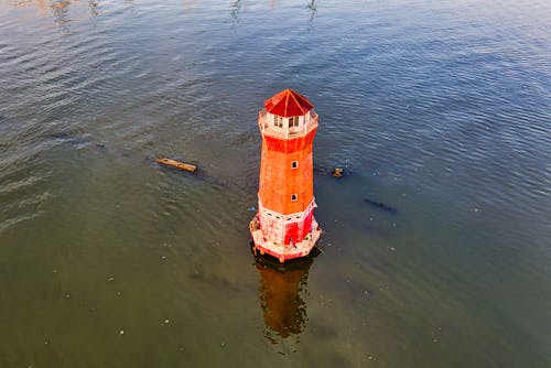 Red and White Lighthouse on Water