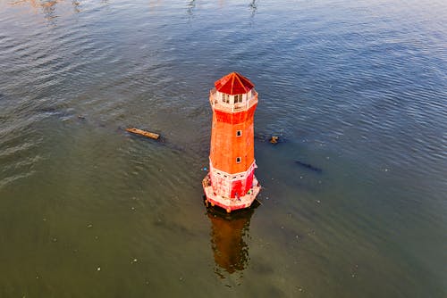 Free Red and White Lighthouse on Water Stock Photo