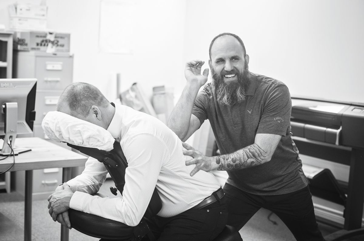On-site corporate chair massage being provided to an employee at work.