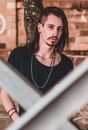 Man in Black Scoop Neck Shirt Wearing Silver Necklace
