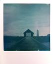 Picture of old house near wooden boardwalk under cloudy sky