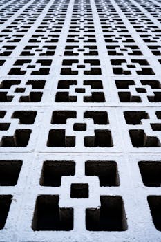 From below of textured background of contemporary style house wall with square shaped holes and shabby surface