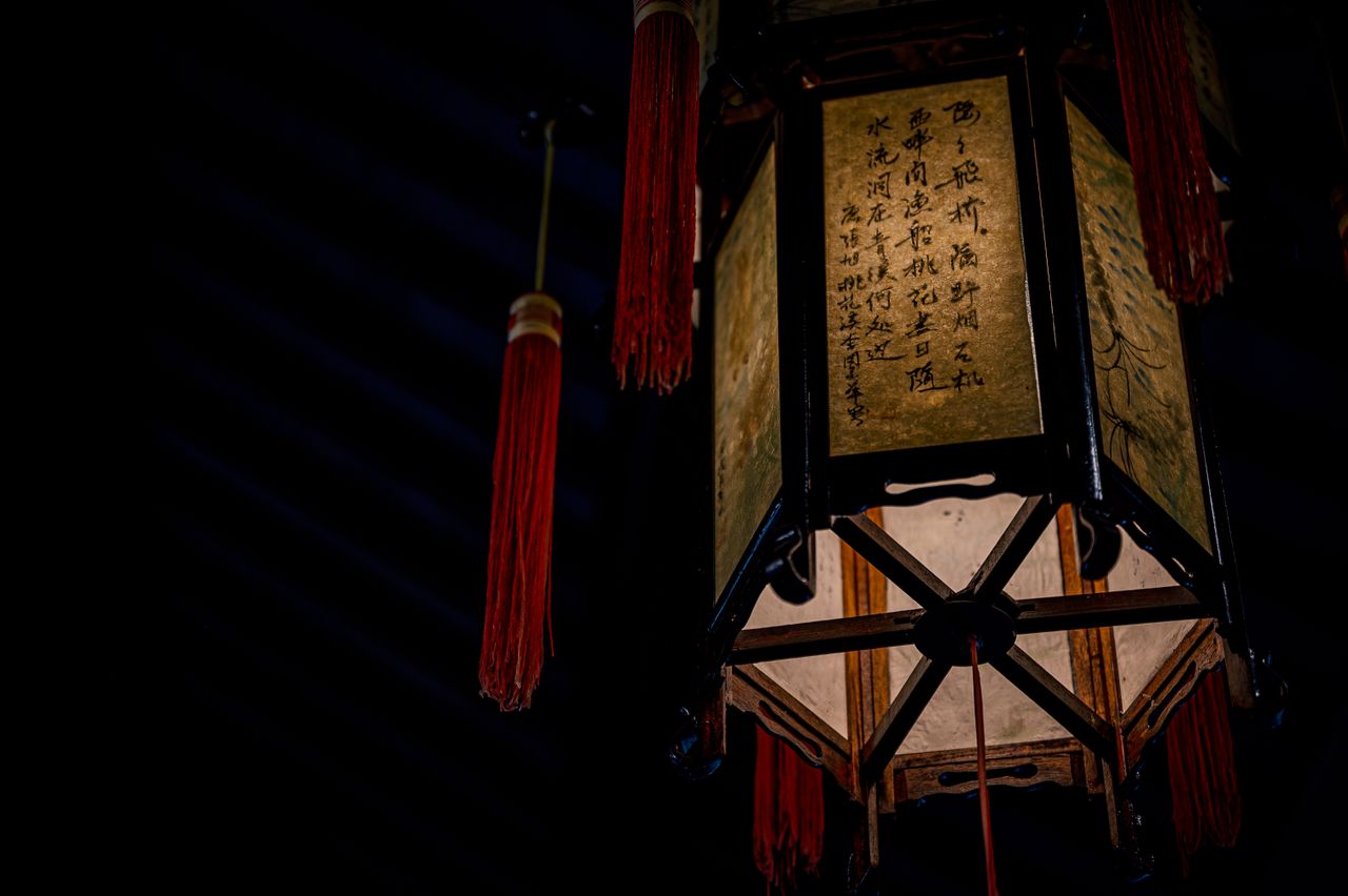 from below of aged symmetric decorative lantern made of wooden beams i