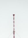 Telecom tower located under gray sky