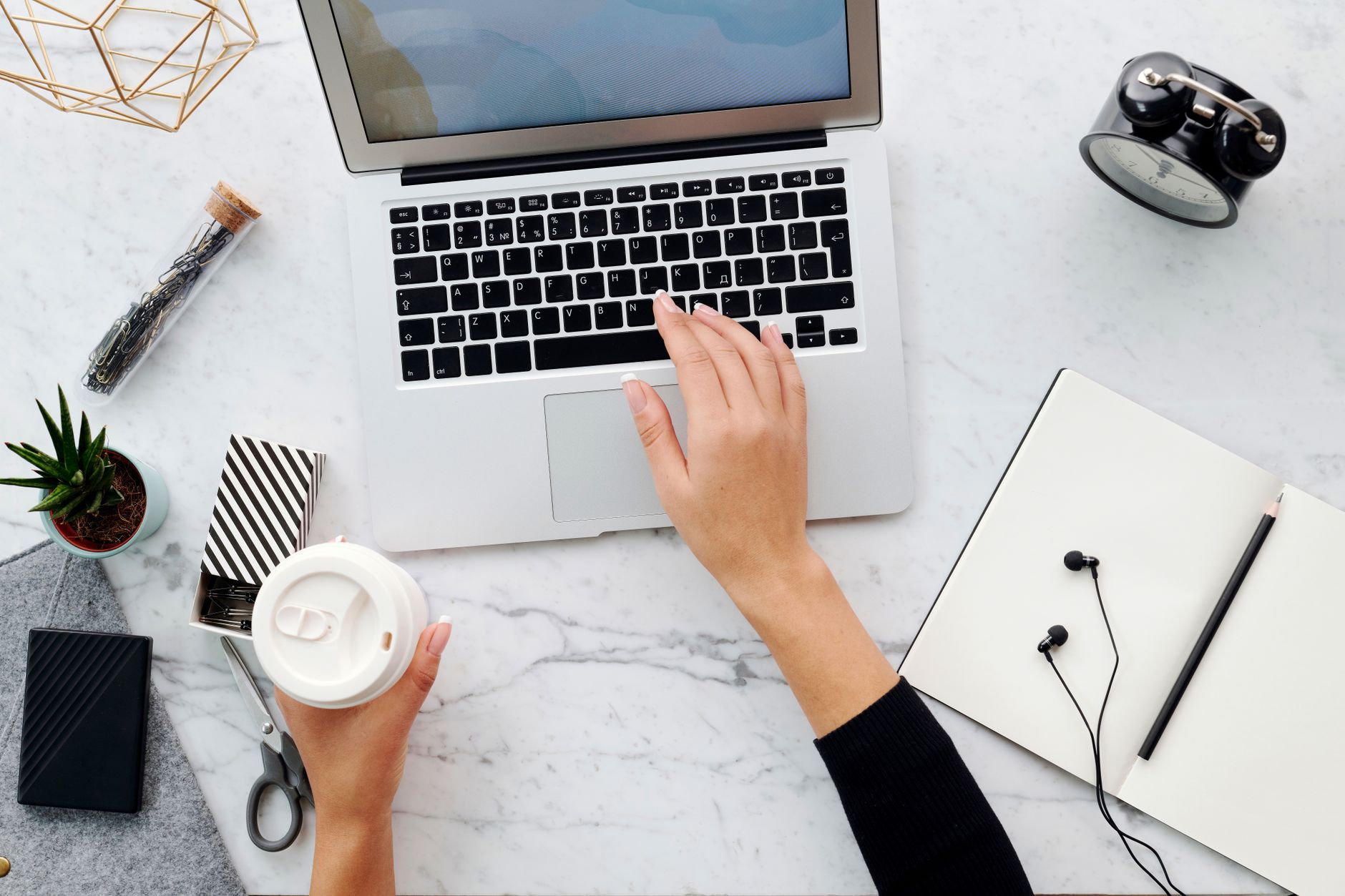 A simple desk with a notebook and a small timer, set up for a twenty-minute writing session