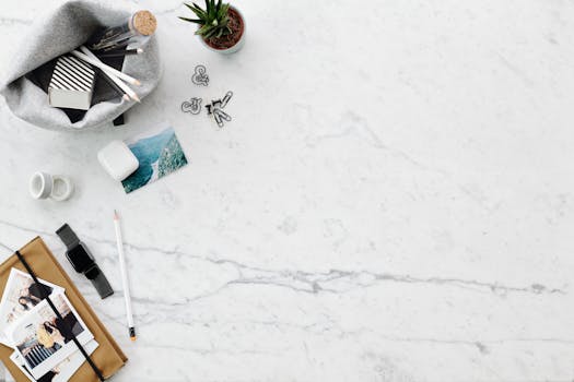A clean and stylish flatlay of a workspace on marble with various items providing ample copy space.