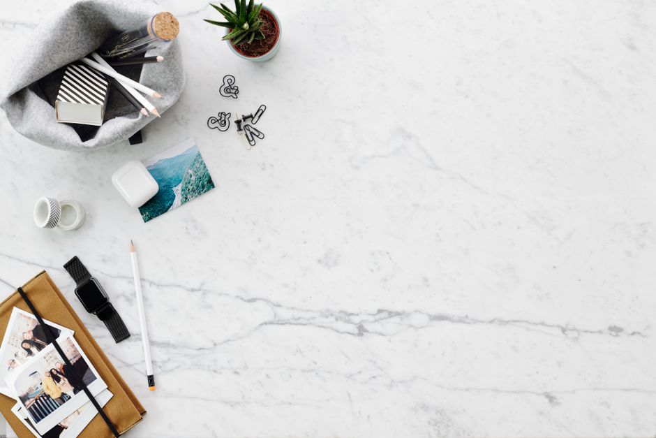 Jasper AI vs Copy AI: Bulk Social Caption Creation Myths Debunked A clean and stylish flatlay of a workspace on marble with various items providing ample copy space.