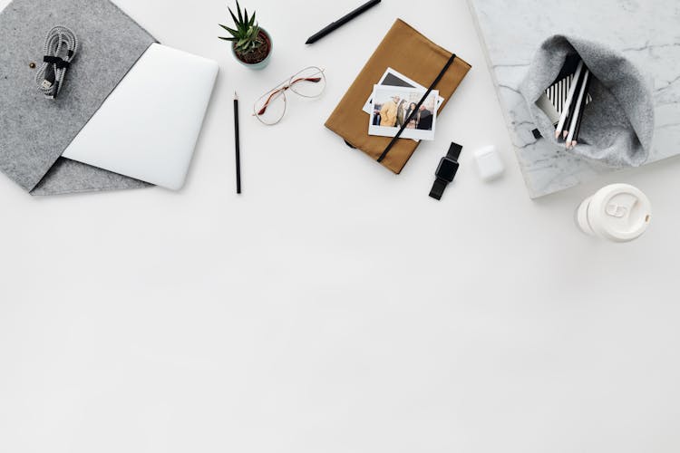 Overhead Shot Of An Ipad And Office Supplies On A White Surface 