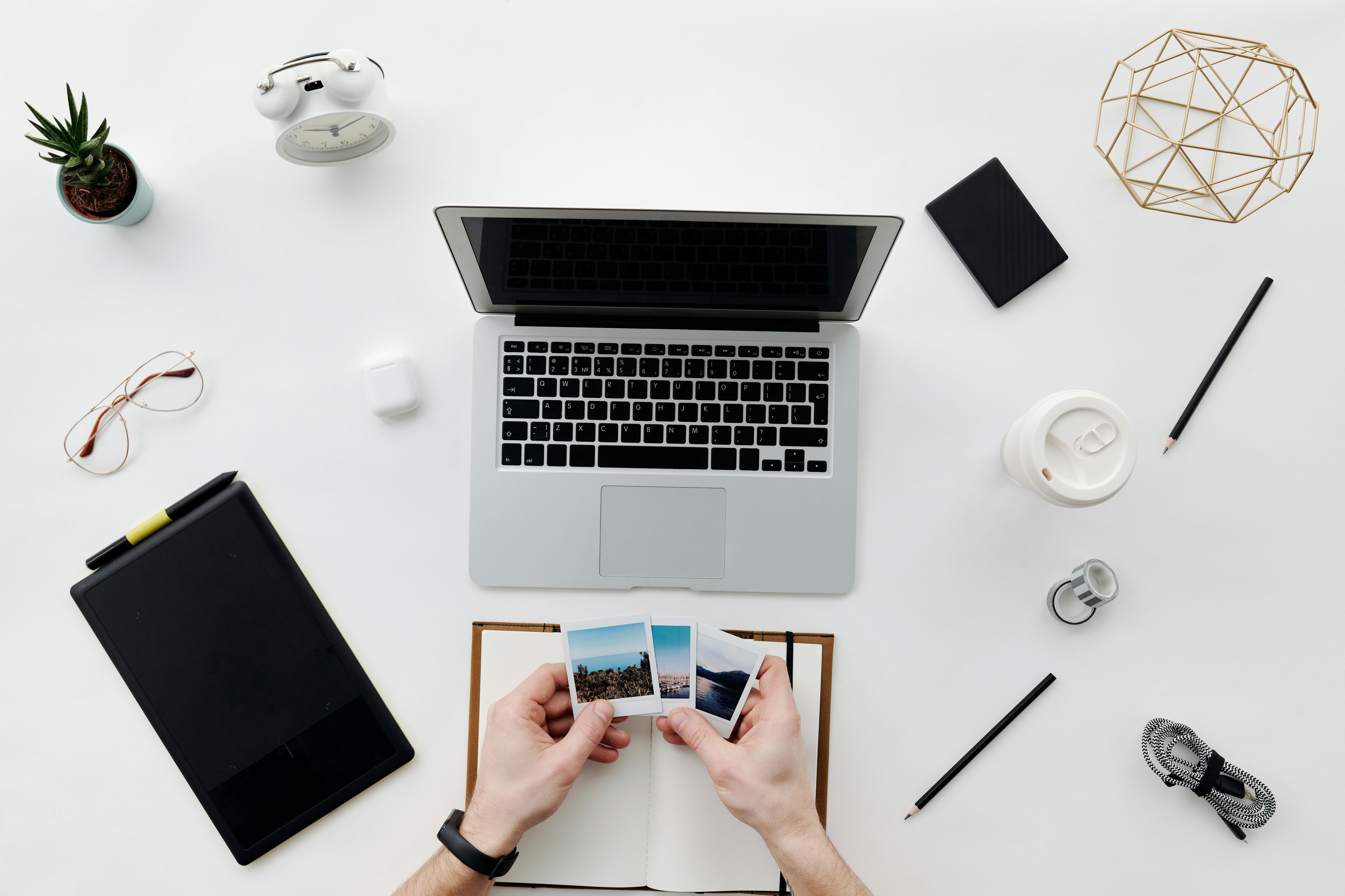 A desk with neatly organized files, a calculator, a pen, and printed photos of property damage. - can you negotiate a settlement with an insurance company