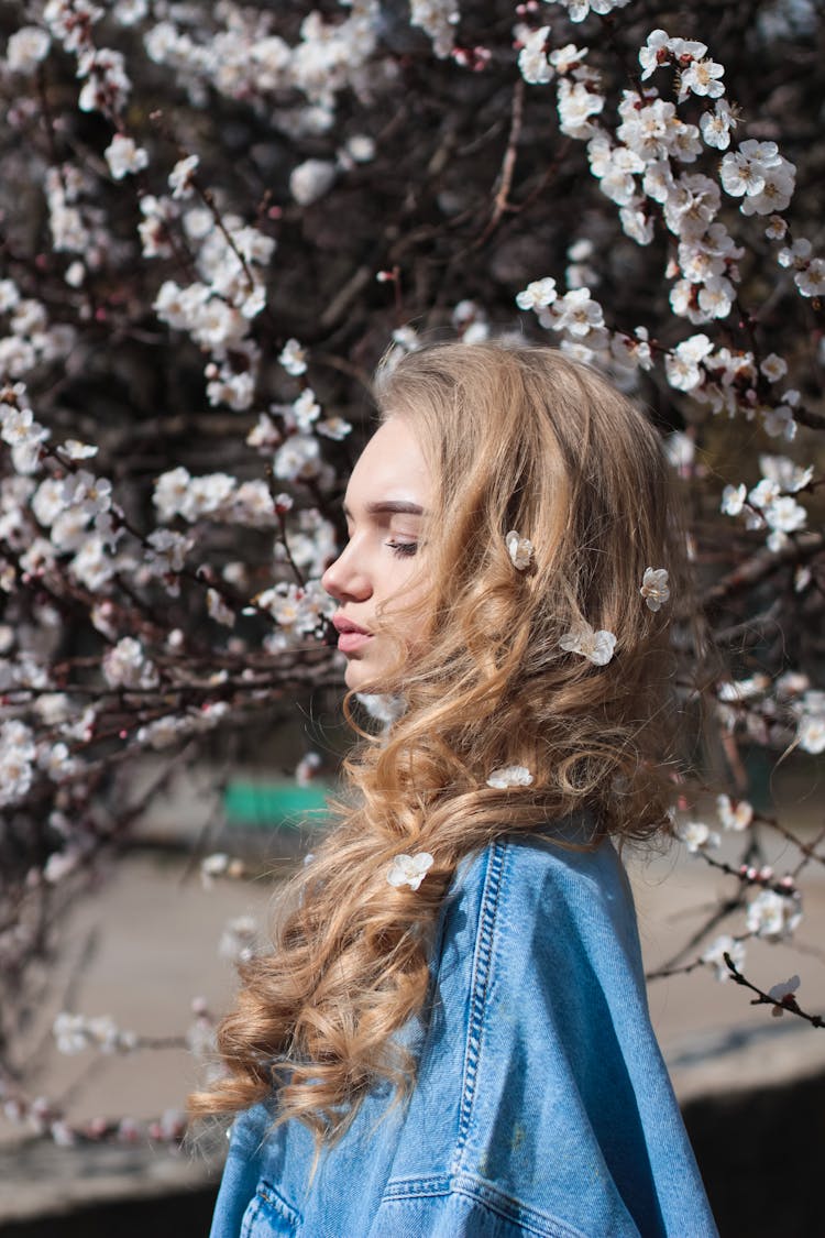 Stylish Young Woman Standing In Spring Park