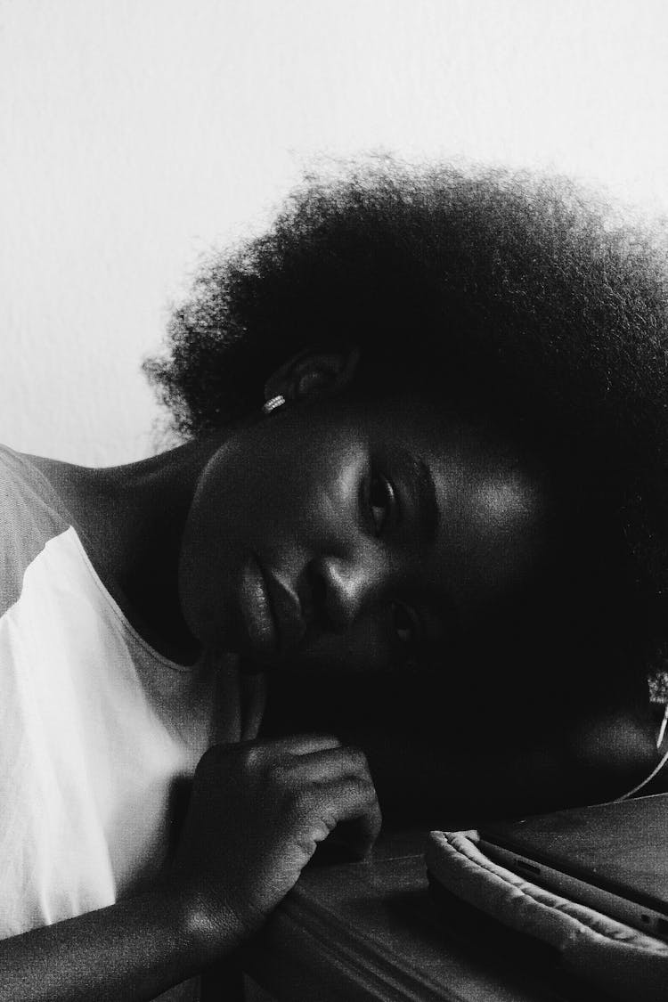 Depressed Ethnic Woman Sitting At Table