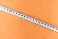 White and Black Ruler on Brown Surface
