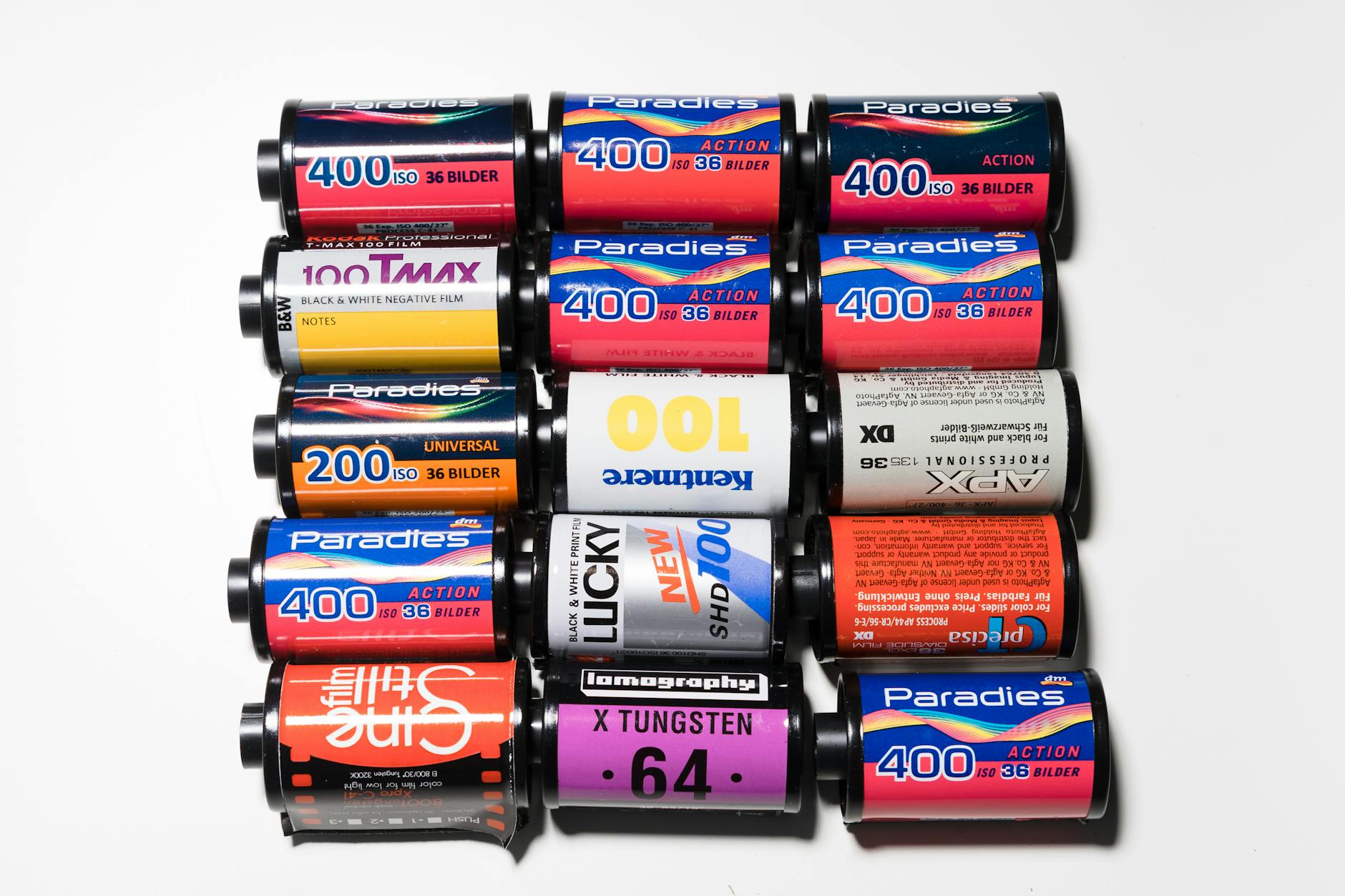 A top view of vintage film cartridges on a white surface
