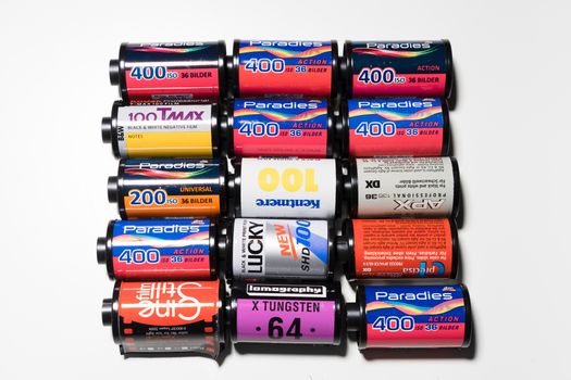 A top view of a collection of vintage film cartridges displayed on a white surface.