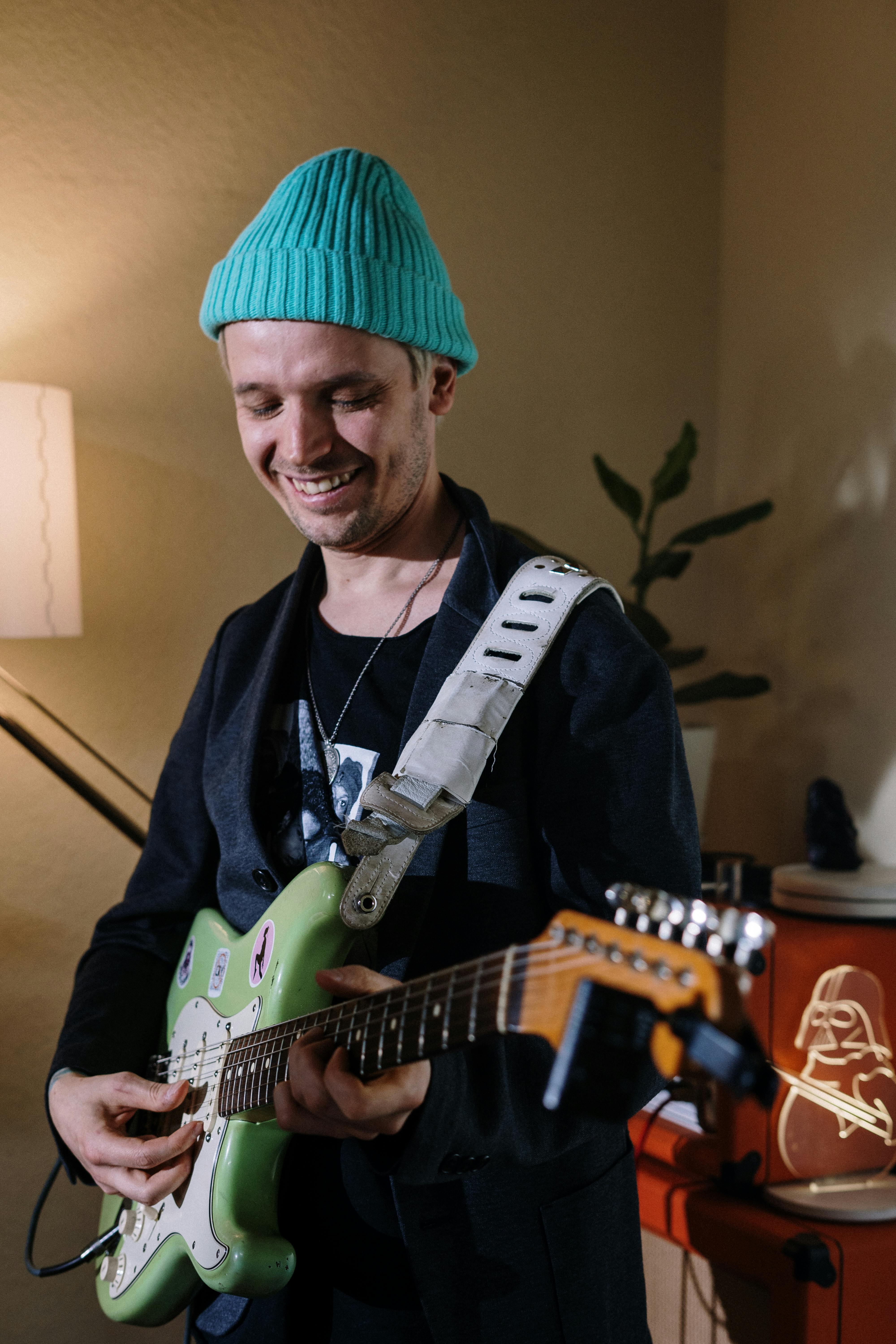 man in black shirt playing electric guitar