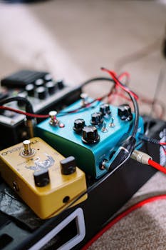 Close-up of colorful guitar effects pedals connected on a pedalboard.