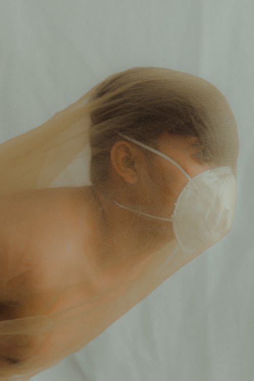 A Topless Man With White Face Mask