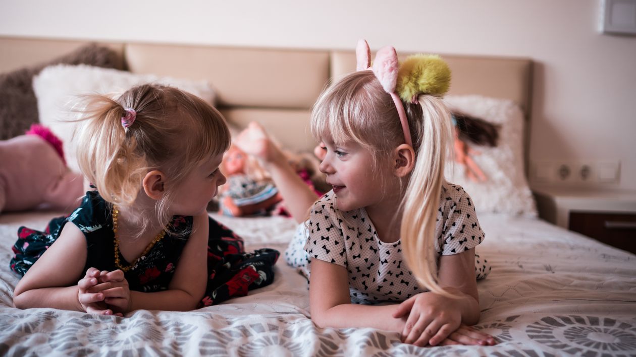 Cute Little Sisters Resting On Bed And Chatting Free Stock Photo Cute Little Sisters Resting On Bed And Chatting Free Stock Photo