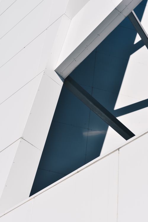 Free Close-up of a futuristic building featuring geometric shapes and bold shadows. Stock Photo