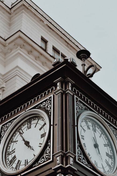 Free A close-up shot of a detailed and ornate vintage clock tower, showcasing its architectural elegance. Stock Photo