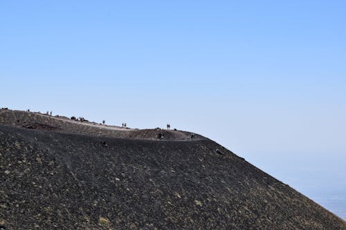 People Walking on the Top of a Volcano 