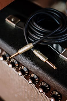 Detailed shot of audio cable on amplifier, perfect for music studio and sound system visuals.