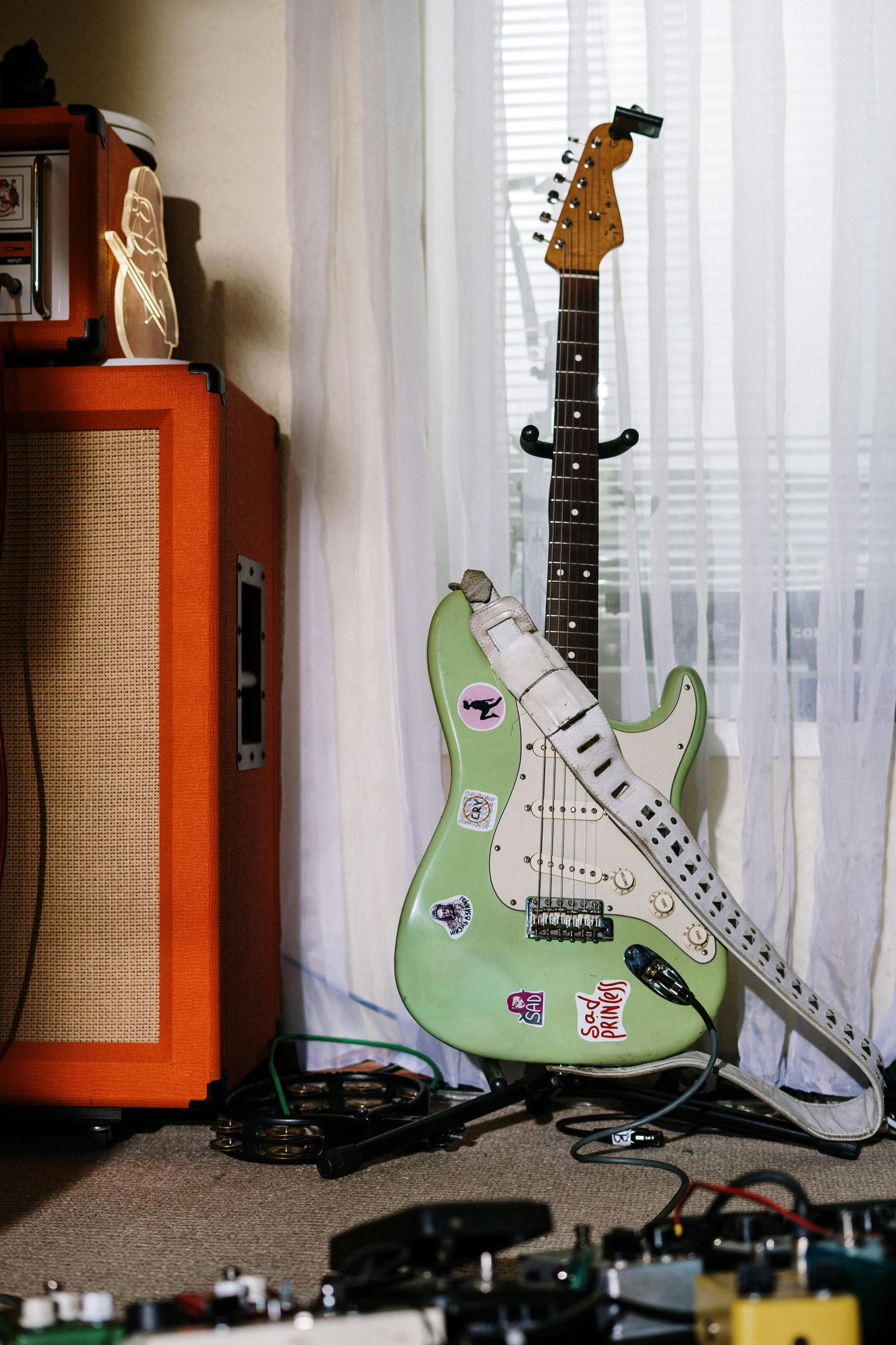 white and greenstratocaster electric guitar