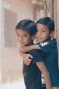 Boy in Blue Polo Shirt Hugging Woman in Black Dress