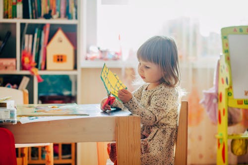 Little Girl Using Scissors