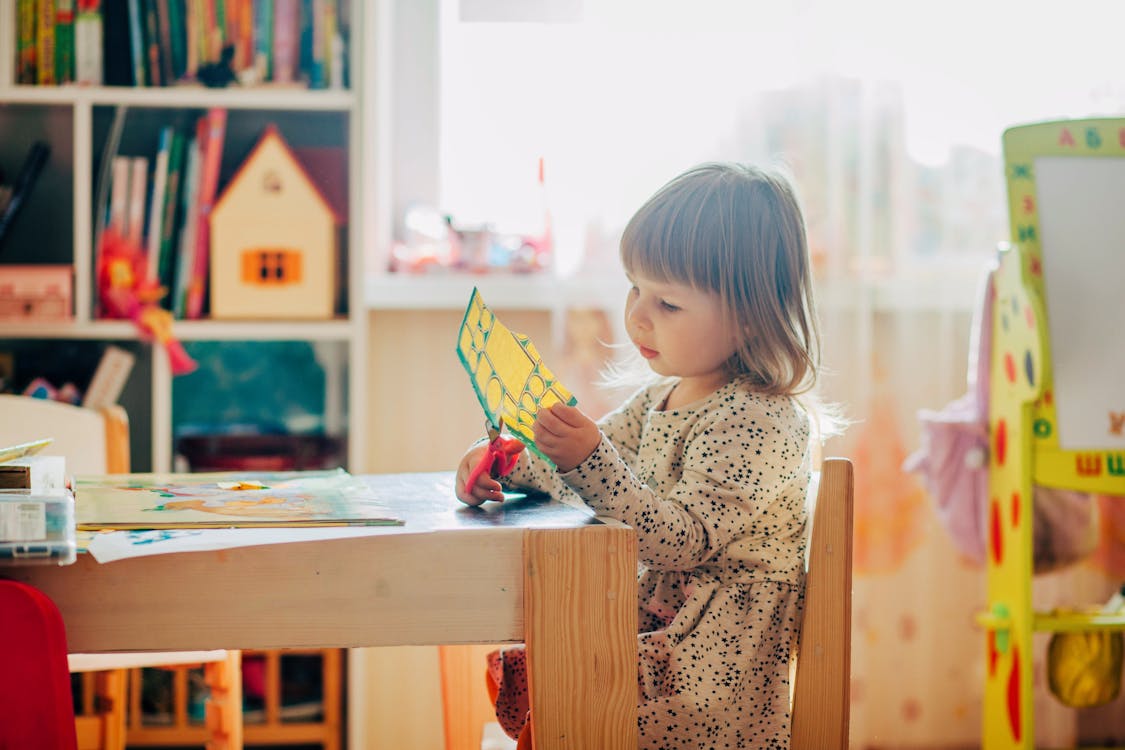 Little Girl Using Scissors