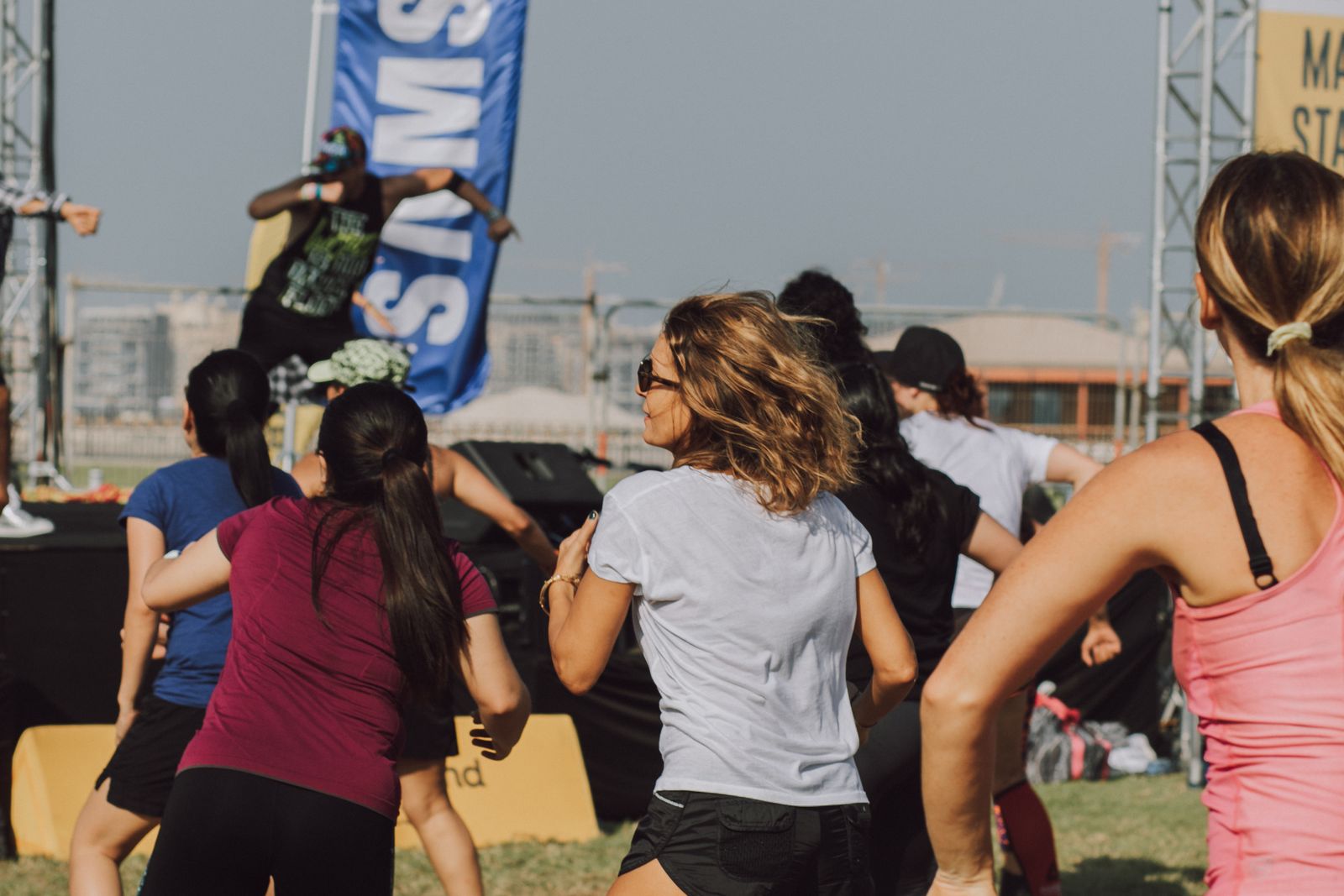 Group of women dancing together in a Zumba class, moving to Latin rhythms