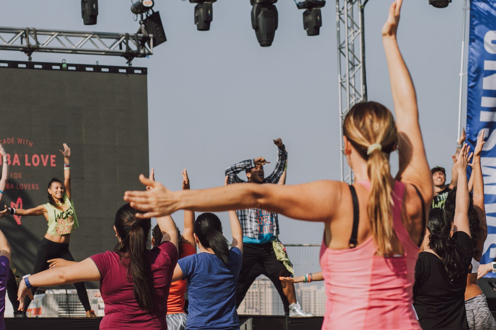 Group of dancers moving together to Latin rhythms in a Zumba dance class