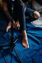 Person in Blue Denim Jeans Sitting on Blue Textile