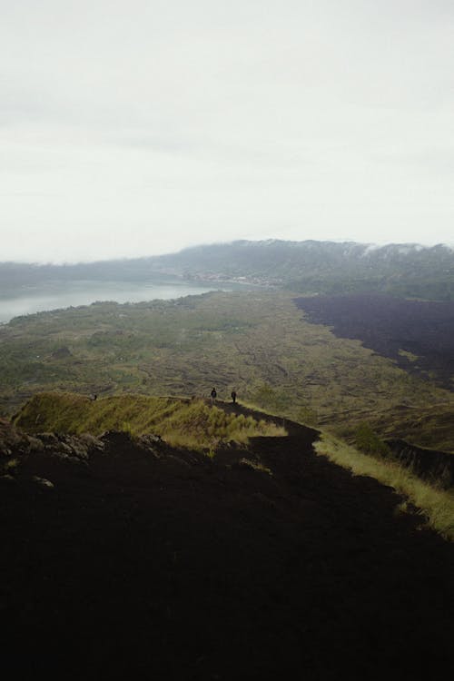 Free Mountainous valley with lake on cloudy day Stock Photo