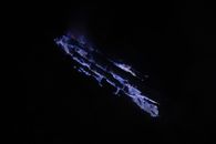 Blue flames in volcano crater at night