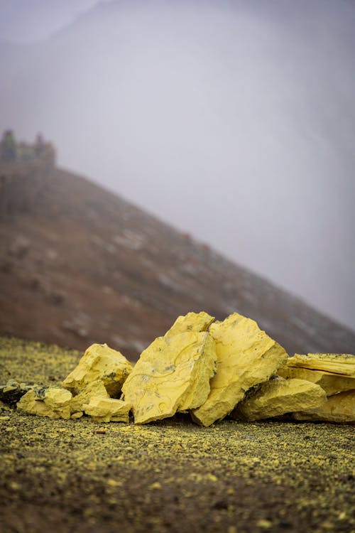 Colorful stones against hillside and cloudy sky