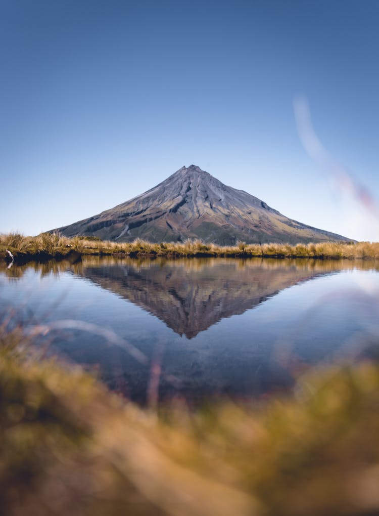 High Mountain Reflecting In Water Surface