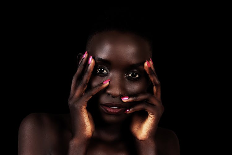 Young Ethnic Woman With Hands On Face