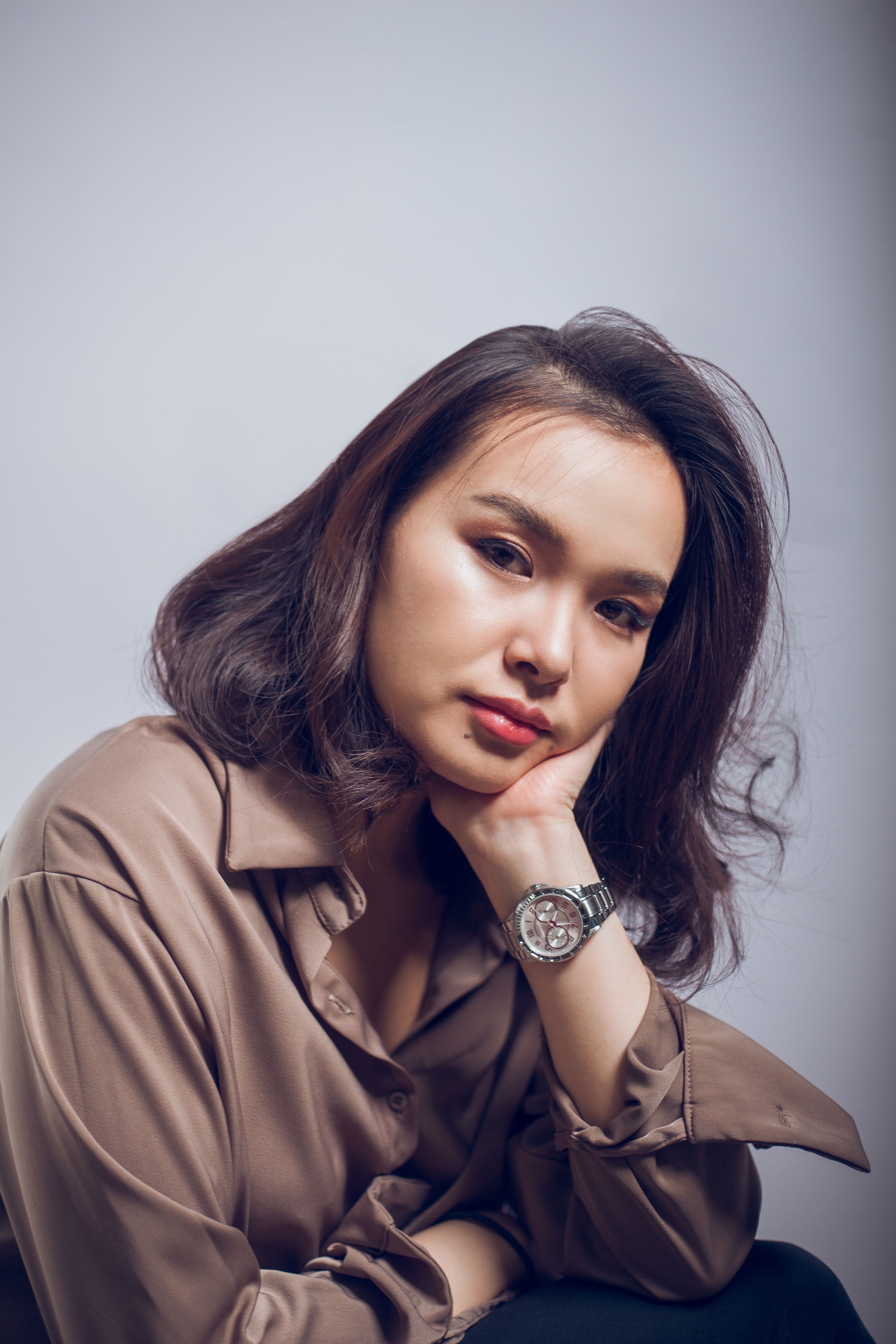 Calm model in formal wear leaning to hand · Free Stock Photo