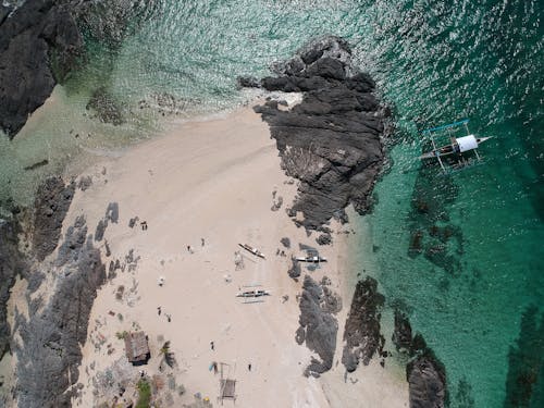 People on Beach near Rocks