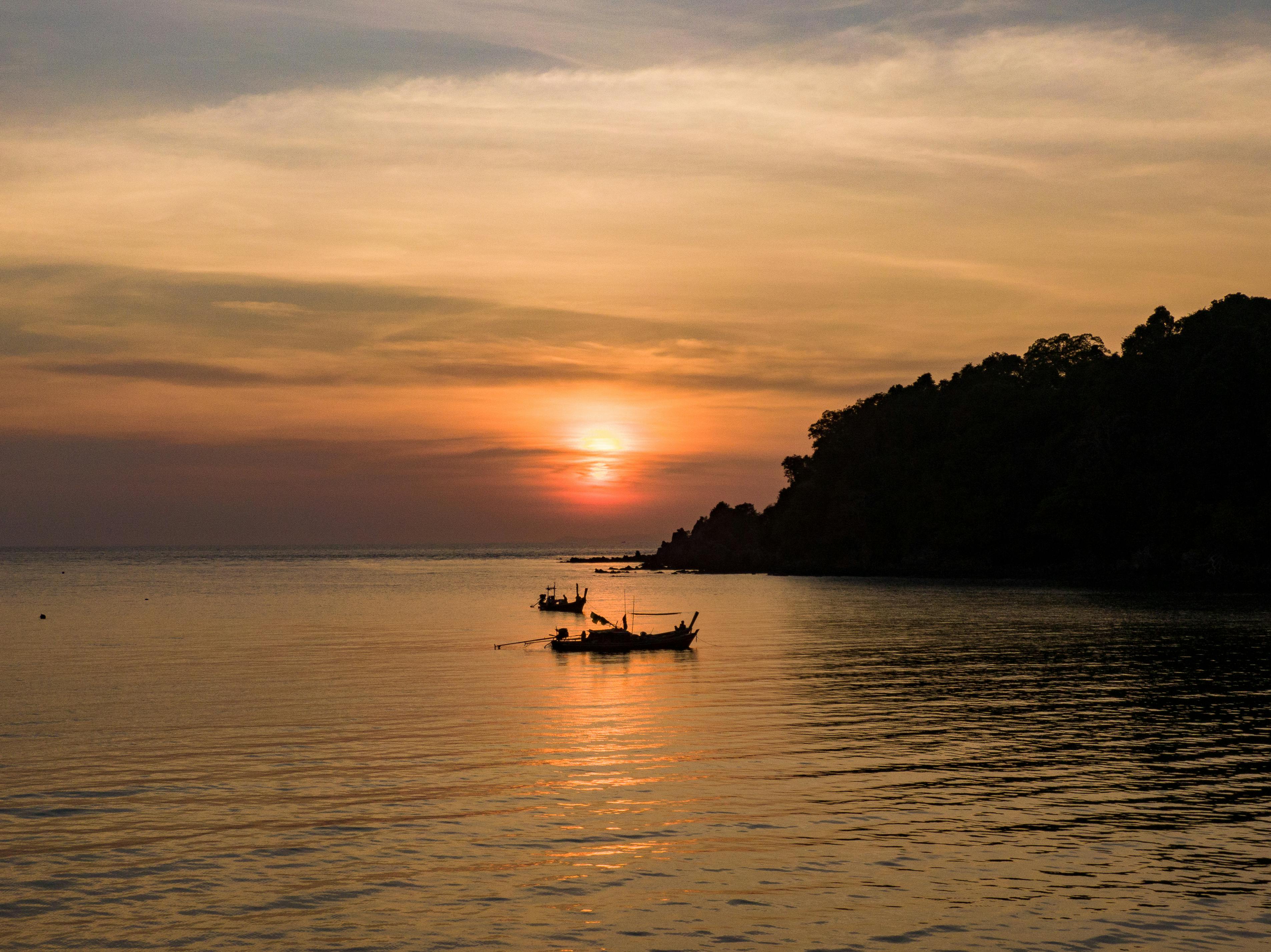 dramatic view of sunset and boat on sea